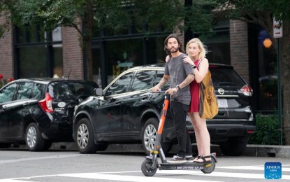 <p><strong>SLOWING ECONOMIC RECOVERY.</strong> People ride a scooter around Navy Yard in Washington D.C., the United States on Aug. 31, 2021. The US economic recovery from the Covid-19 pandemic is slowing due to the spread of the Delta variant and a sizable segment of unvaccinated people, Joseph Brusuelas, chief economist at accounting and consulting firm RSM US LLP, said on Tuesday. <em>(Photo by Ting Shen/Xinhua)</em></p>