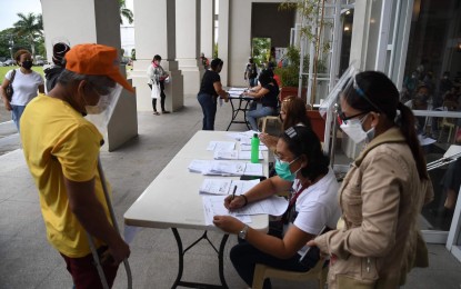 <p><strong>BENEFICIARY</strong>. A person with disability (right), was among those who received financial assistance in Bacolod City under the Department of Social Welfare and Development Assistance to Individuals in Crisis Situation program. Each beneficiary was provided PHP3,000 during the payout held at the main lobby of the Government Center on Wednesday (Sept. 1, 2021). <em>(Photo courtesy of Bacolod City PIO)</em></p>