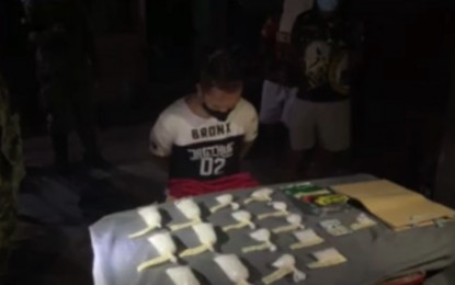 <p><strong>DRUG HAUL.</strong> Photo shows drug suspect Manuel Requinto Rafols alias "JR Mojako", 33, sitting in front of the evidence seized from him during the buy-bust operation in Mambaling, Cebu City on Tuesday night (Aug. 31, 2021). PRO-7 chief Brig. Gen. Ronnie Montejo on Thursday (Sept. 2) commended the Cebu City Police for the arrest of three high-value drug personalities and seizure of PHP6.5 million worth of shabu in three separate operations on August 31 and September 1.<em> (Screengrab from Col. Josefino Ligan's FB video)</em></p>