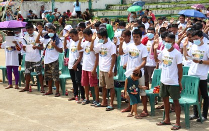 <p><strong>LEAVING NPA</strong>. Some of the 282 fighters and supporters of the New People's Army (NPA) in Silvino Lubos, Northern Samar pledging allegiance to the Philippine government after formally abandoning the NPA on this Aug. 2, 2021 photo. The mass surrender has further weakened the communist terrorist group in the province, a Philippine Army official said on Thursday (Sept. 2, 2021). <em>(Photo courtesy of Philippine Army)</em></p>