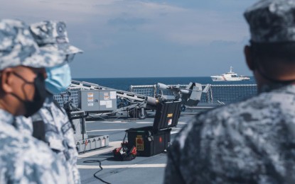 <p><strong>PARTNERS.</strong> Members of the Philippine Coast Guard watch as a small unmanned aircraft system is launched off the flight deck of USCG Cutter Munro during a maritime engagement on Aug. 31, 2021, in the West Philippine Sea. Operating under the tactical control of US 7th Fleet, the cutter and crew are engaging in professional exchanges and capacity-building exercises with partner nations and are patrolling and conducting operations as directed. <em>(Photo courtesy of Marine Corps Sgt. Kevin Rivas, US Coast Guard)</em></p>