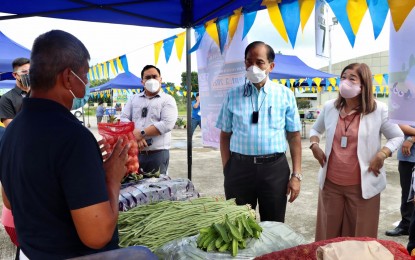 <p><strong>‘CARRY ON’.</strong> Agriculture Secretary William Dar (2nd from right) encourages farmers manning the booths during the opening of the Kadiwa ni Ani at Kita farmers’ exhibit at the DA - Philippine Carabao Center grounds in the Science City of Muñoz, Nueva Ecija on Friday (Sept. 3, 2021). The opening of the Kadiwa is in support of the DA's twin objectives of “masaganang ani (bountiful harvest)” and “mataas na kita (higher income)” for farmers and fisherfolk. <em>(Photo courtesy of DA-PCC)</em></p>