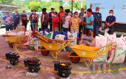 <p><strong>INCOME-GENERATING ASSISTANCE.</strong> The Department of Agriculture distributes PHP1.2-million worth of livelihood assistance to 200 farmers of a Manobo indigenous community in Barangay Domolol Palimbang, Sultan Kudarat on Thursday (Sept. 2, 2021). Among the items were farm implements such as tillers, wheelbarrows, shovels, spades, rakes, and small motor machines for irrigation. <em>(Photo courtesy of DA-12)</em></p>