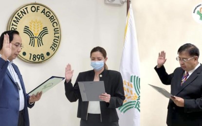 <p><strong>CHALLENGE ACCEPTED.</strong> Department of Agriculture Secretary William Dar (left) swears into office Undersecretaries Kristine Evangelista (center) and Dr. Fermin Adriano on Monday (Sept. 7, 2021). Adriano will oversee policy formulation, planning, and research while Evangelista will chair the Bantay Presyo advisory committee and handle political affairs. <em>(Photo courtesy of DA)</em></p>