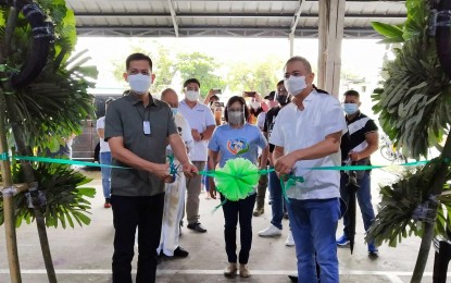 <p><strong>VACCINATION SITE</strong>. Second District Rep. Jose Enrique Garcia III (left) and Governor Albert Garcia cut the ceremonial ribbon during the opening of another vaccination site against coronavirus disease 2019 in Orion, Bataan on Wednesday (Sept. 8, 2021). This is the 28th vaccination site in the province. <em>(Contributed photo)</em></p>