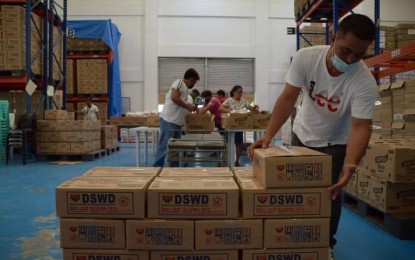 <p><strong>TYPHOON AID</strong>. A worker stacks up family food packs inside a government warehouse in Palo, Leyte. The Department of Social Welfare and Development (DSWD) has readied 10,825 family food packs for victims of Typhoon Jolina in the Eastern Visayas region, the agency reported on Thursday (Sept. 9, 2021). <em>(Photo courtesy of DSWD)</em></p>