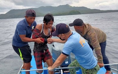 <p><strong>RESCUE.</strong> Members of the Santo Niño, Samar police rescue at least 50 fishermen as Typhoon Jolina slams the province in this undated photo. The typhoon made its first landfall in Hernani, Eastern Samar on the night of Sept. 6, followed by four more in Samar towns, including Santo Niño. <em>(Photo courtesy of Santo Niño MPS)</em></p>