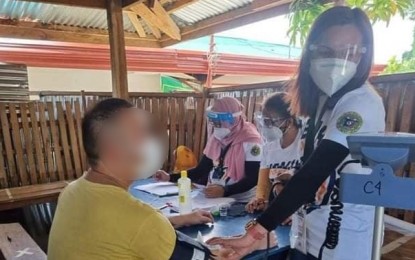 <p><strong>PRE-JAB CHECK</strong>. A nurse from the Cotabato City health office checks the blood pressure of an inmate before his immunization for coronavirus disease 2019 on Sunday (Sept. 12, 2021). At least 58 PDLs from the city’s three police stations were vaccinated against the disease.<em> (Photo courtesy Cotabato CHO)</em></p>