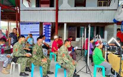<p><strong>BIOMETRICS.</strong> Uniformed men line up for the Step 2 biometrics process of the Philippine Identification System in Barangay Dungon, Banguingui, Sulu on Aug. 13, 2021. The second phase includes validation of supporting documents and capture of fingerprints, iris scan and photographs. <em>(Photo courtesy of Banguingui, Sulu Facebook)</em></p>