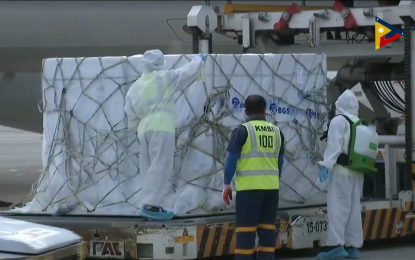 <p><strong>2M MORE DOSES.</strong> Airport personnel disinfect the new shipment of Sinovac Covid-19 vaccine upon arrival at the Ninoy Aquino International Airport Terminal 2 in Pasay City on Monday (Sept. 13, 2021). The additional 2 million doses are part of the 12 million ordered from Sinovac for September. <em>(Screengrab from PTV-4 Facebook page)</em></p>