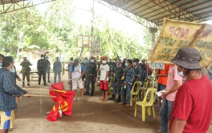 <p><strong>ANTI-REBELS.</strong> Residents of Barangay Minapasuk in Calatrava, Negros Occidental burn communist flags and denounce their atrocities in this November 2020 photo. The military revealed that insurgents recruit even minor family members. <em>(Photo courtesy of 79IB Facebook)</em></p>