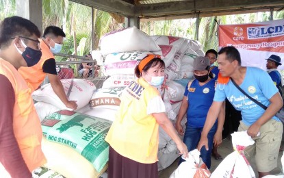 <p><strong>DENIED</strong>. Leyte Center for Development, Inc. (LCDe) executive director Jasmin Jerusalem (center) distributing sacks of rice to typhoon victims in Eastern Samar in this June 2, 2020 photo. The non-government organization based in Leyte has denied links to the New People’s Army but the military said information came from former rebels. <em>(Photo courtesy of LCDe)</em></p>