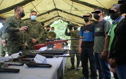 <p><strong>WORK IN PROGRESS.</strong> 23rd Infantry Battalion commander Lt. Col. Julius Cesar C. Paulo (2nd from left) presents to Philippine Army commanding general, Maj. Gen. Andres Centino (left), the top leader and eight remnants of dismantled Guerrilla Front 4A of the New People’s Army at the unit’s headquarters in Barangay Alubihid, Buenavista, Agusan del Norte on Sept. 15, 2021. President Rodrigo Roa Duterte on Thursday (March 31, 2022) said the journey towards dismantling communist-terrorist groups in the country remains a "work in progress.” <em>(Photo courtesy of 4ID)</em></p>