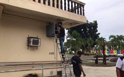 <p><strong>CONNECTED.</strong> A local government worker installs free WIFI in Burgos, Siargao Island, Surigao del Norte in this undated photo. President Ferdinand R. Marcos Jr. on Monday (July 22, 2024) said almost 10 million unique user devices have so far connected to 13,000 free WiFi areas across the country, with plans to install more to connect more Filipinos to the internet.<em> (Photo courtesy of the local government of Burgos)</em></p>