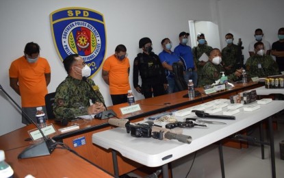 <p><strong>NABBED.</strong> Police present to the media on Monday (Sept. 20, 2021) two suspected gunrunners who yielded several high-powered firearms during an operation last week in the cities of Taguig and Mandaluyong. The two are facing a string of charges that include illegal possession of firearms, among others. <em>(Photo courtesy of SPD)</em></p>