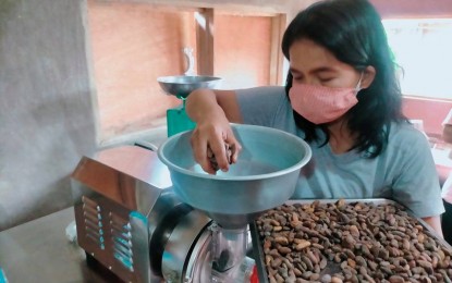 <p><strong>CACAO PROCESSING</strong>. A member of the Adams Cacao Growers and Processors Association Inc. tries a grinder machine at the Shared Service Facility for Cacao Processing on Wednesday (Sept. 22, 2021). The cacao processing facility worth more than PHP1 million is a grant from the Department of Trade and Industry which aims to boost local livelihood of Indigenous Peoples (IPs) in the area. (<em>Photo courtesy of Frances Kristy A. Daguimol</em>) </p>