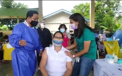 <p><strong>JABS FOR VILLAGE OFFICIALS</strong>. Antique Liga ng mga Barangays (LnB) president Pamela Socorro Azucena receives a Covid-19 vaccine on May 18, 2021. Azucena on Friday (Sept. 24, 2021) said more than 1,000 barangay captains and officials in the province have been inoculated. <em>(Photo courtesy of Antique LnB)</em></p>