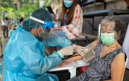 <p><strong>VAX ROLLOUT</strong>. A health worker checks the blood pressure of a senior citizen before administering the first dose of Covid-19 vaccine. To speed up the mass vaccination drive, walk-ins or those who are accompanying seniors to the vaccination sites are getting their vaccines too, even if they are not on schedule. (<em>PNA photo by Leilanie G. Adriano</em>) </p>