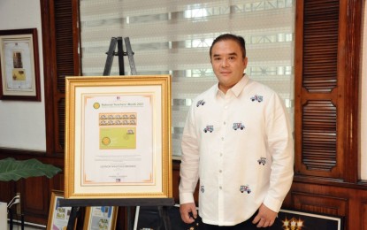 <p>Postmaster General Norman Fulgencio poses with the newly released National Teachers' Month Stamp.<em> (Contributed photo)</em></p>