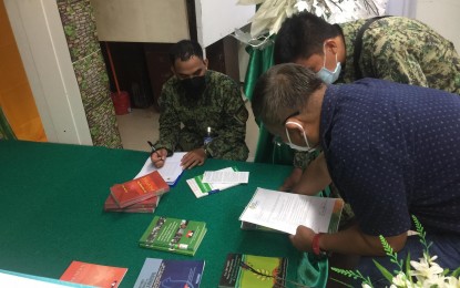 <p><strong>SUBVERSIVE.</strong> Members of the Aklan Police make an accounting of subversive textbooks and reading materials turned over by the Aklan State University - Banga campus on Friday (Sept. 24, 2021). The university is the first tertiary-level institution in the Visayas to surrender such reading materials. <em>(Photo courtesy of Banga MPS Facebook)</em></p>