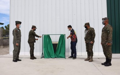 <p><strong>INAUGURATION.</strong> DPWH Secretary Mark Villar (3rd from right), together with some military officials, leads the inauguration of the new hangar facility of the Philippine Army's Aviation Regiment at Fort Magsaysay, Palayan City, Nueva Ecija on Saturday (Sept. 25, 2021). The project was implemented by the Department of National Defense, and the Department of Public Works and Highways under the Tatag ng Imprastruktura para sa Kapayapaan at Seguridad program. <em>(Photo by Marilyn Galang)</em></p>