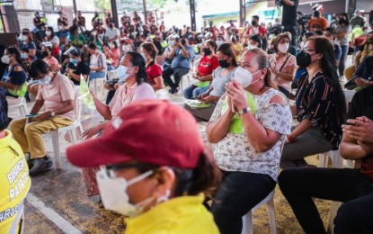 <p><strong>NEW LANDOWNERS.</strong> Payatas residents receive the good news on Sunday (Sept. 26, 2021) that they can now own the land they have been living in for 40 years. The Quezon City government will acquire the property from Land Bank of the Philippines. <em>(Photo courtesy of QC Government)</em></p>