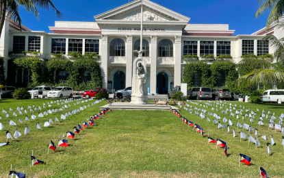 <p><strong>HONORING LIVES LOST</strong>. Almost 400 flaglets are planted at the Ilocos Norte Capitol ground on Monday (Sept. 27, 20210 in honor of the victims of Covid-19 in the province. It is also a reminder for the public to do their part in preventing such deaths. (<em>PNA photo by Leilanie G. Adriano</em>) </p>