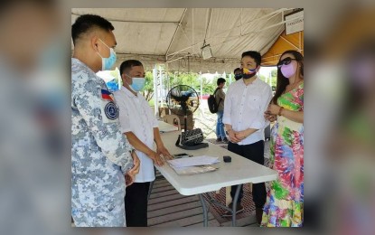 <p><strong>WEDDING AT THE BORDER.</strong> Erwin (second from right) and Ruby exchange their vows before an officiating officer and a staff of the Philippine Coast Guard (left) at the border checkpoint in Urdaneta City, Pangasinan on Sunday (Sept. 26, 2021). The couple was set to be married on that day but Erwin and his companions were not allowed entry due to lack of necessary documents.<em> (Photo courtesy of Irondicz Wedding Officiant Facebook page)</em></p>