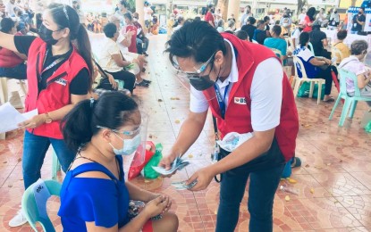 <p><strong>CASH AID.</strong> Personal distribution of financial assistance by the Department of Social Welfare and Development, like in this undated photo, will soon be a thing of the past. The agency will migrate to digital means using the Philippine Identification System to verify its beneficiaries. <em>(Photo courtesy of DSWD-10)</em></p>