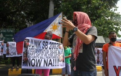 <p><strong>ANTI-REDS.</strong> Protesters against the University of the Philippines–Department of National Defense accord rally outside the Senate building in Pasay City on Tuesday (Sept. 28, 2021). They said the State University will become a haven for terrorists once the UP Security Bill is passed. <em>(PNA photo by Avito Dalan)</em></p>