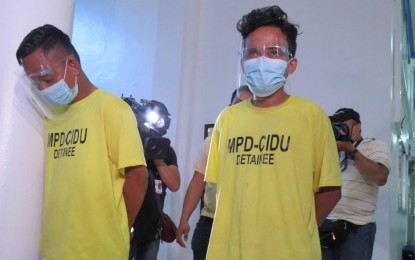 <p><strong>NABBED.</strong> MPD operatives present two suspects in the September 27 robbery at the Chinabank Otis branch in Paco, Manila on Thursday (Sept. 30, 2021). The PNP has ordered the Intelligence Group and other concerned units to conduct an extensive background check against criminal personalities involved in recent robbery and kidnapping incidents. <em>(Photo grabbed from MPD Facebook page)</em></p>