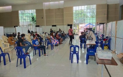 <p><strong>VACCINATION</strong>. Workers from the construction and manufacturing sectors in Bulacan province receive Covid-19 jabs in Malolos City on Friday (Oct. 1, 2021). A total of 1,400,793 Bulakenyos have been vaccinated in the province, the Provincial Health Office said. <em>(Photo by Manny Balbin)</em></p>
