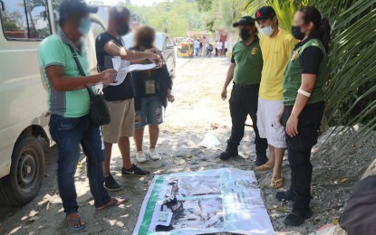 <p><strong>BUSTED.</strong> A witness signs the inventory sheet of the recovered illegal drugs from contractual government employee Jamil Desamito (in yellow shirt, 2nd from right), 40, who was arrested in a buy-bust led by the Philippine Drug Enforcement Agency-Region 12 in Barangay Sta. Cruz, Koronadal City on Thursday. The suspect is listed as a high-value target drug personality and has a pending case for the same offense. <em>(Photo courtesy of PDEA-12)</em></p>
