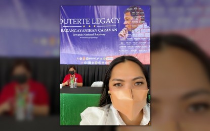 <p><strong>THANKFUL.</strong> Braulio E. Dujali Mayor Leah Marie Moral-Romano poses for a selfie in front of a tarpaulin of President Rodrigo Duterte during the 'Duterte Legacy Barangayanihan Caravan' held in her town on Thursday (Sept. 30, 2021). Romano thanked the Duterte administration for the development it has brought to her municipality. <em>(Photo courtesy of Atty. Tata Moral-Romano Facebook Page)</em></p>