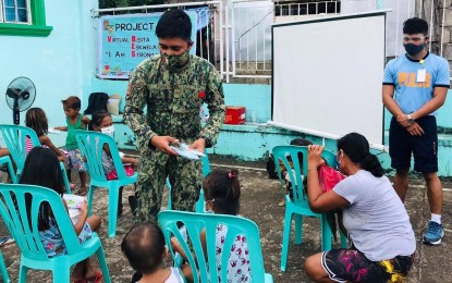 <p><strong>BEYOND THE CALL OF DUTY.</strong> When not going after criminals or keeping peace and order, these Catanduanes province cops educate children on their rights and how to fight abusers. On Sept. 11, 2021, they went to Barangay Timbaan in San Andres town and discussed how children can protect themselves and the readiness of the police to assist them. <em>(Photo courtesy of PCADG-Bicol)</em></p>