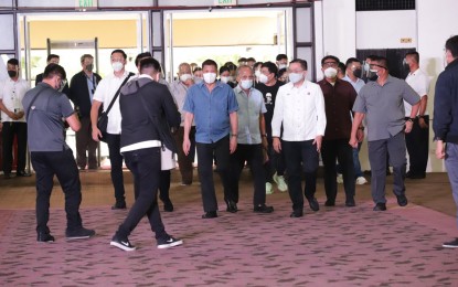 <p><strong>DAY 2 SURPRISE.</strong> President Rodrigo Duterte and Senator Bong Go (3rd and 4th from left) arrive at the Sofitel Harbor Garden Tent in Pasay City on Saturday (Oct. 2, 2021). Go filed his candidacy for Vice President while Duterte announced his retirement from politics. <em>(PNA photo by Robert Oswald P. Alfiler)</em></p>