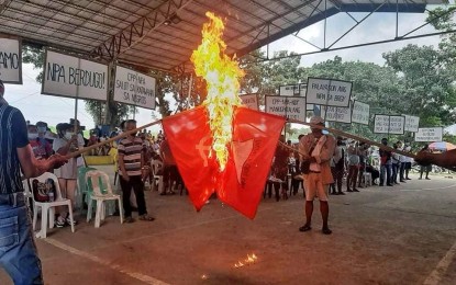 <p><strong>DESIRE FOR PEACE</strong>. Replica flags of the Communist Party of the Philippines-New People’s Army were burned during a peace rally participated in by members of four farmers associations in Barangay E. Lopez in Silay City, Negros Occidental on Oct. 2, 2021. The farmers said they have abandoned their membership with the National Federation of Sugarcane Workers, which is considered by government forces as a legal front of the CPP-NPA. <em>(Photo courtesy of 79th Infantry Battalion, Philippine Army)</em></p>