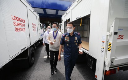 <p><strong>DISASTER RESPONSE EQUIPMENT.</strong> Philippine National Police (PNP) chief, Gen. Guillermo Eleazar, and Japanese Ambassador to Manila Kazuhiko Koshikawa walk past the rescue vehicles that are part of Japan's disaster equipment donation which was turned over to the PNP in Camp Crame, Quezon City on Monday (Oct. 4, 2021). The donation is funded under Tokyo's “Economic and Social Development Programme” worth JPY 2.5 billion (around PHP1.1 billion).<em> (Photo courtesy of PNP)</em></p>