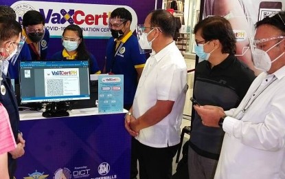 <p><strong>SOFT LAUNCH</strong>. Health Secretary Francisco Duque III and officials of the Inter-Agency Task Force for the Management of Emerging Infectious Diseases and National Task Force Against Covid-19 lead the soft launch of the VaxCertPH program, a portal for the issuance of coronavirus disease 2019 vaccination certificates to fully inoculated Filipinos going abroad at the SM City Clark in Pampanga on Monday (Oct. 4, 2021). The Department of the Interior and Local Government and Department of Information and Communications Technology are now preparing the list of vaccinated individuals based on the data of the local government units in preparation for the program's nationwide launch.<em> (Photo by Marna Del Rosario)</em></p>
