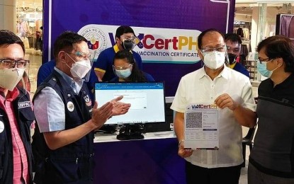<p><strong>NATIONAL CERTIFICATE.</strong> National Task Force Against Covid-19 chief Secretary Carlito Galvez Jr. (3rd from left) leads the signing of the pact between the NTF and Inter-Agency Task Force for the Management of Emerging Infectious Diseases to implement VaxCertPH at a mall in Clark, Pampanga on Monday (Oct. 4, 2021). The national vaccine certification system is initially intended for Filipinos going abroad. <em>(PNA photo by Marna Dagumboy-Del Rosario)</em></p>