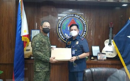 <p><strong>REDS' ATROCITIES.</strong> AFP Center for Law of Armed Conflict chief, Brig. Gen. Joel Alejandro Nacnac (left), submits a total of 1,672 incidents of IHL violations of the communist terrorist group to CIDG chief, Maj. Gen. Albert Ignatius Ferro (right). in Camp Crame, Quezon City on Wednesday (Oct. 6, 2021). The AFPCLOAC also submitted the list to the National Task Force to End Local Communist Armed Conflict’s Legal Cooperation Cluster.<em> (Photo courtesy of AFP)</em></p>