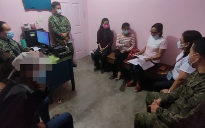 <p><strong>YOUNG COMBATANT</strong>. Troops of the Philippine Army’s 94th Infantry Battalion and Himamaylan City Police Station endorse CPP-NPA child warrior alias “RR” (seated left) to the City Social Welfare Department after his surrender on Oct. 4, 2021. The 15-year-old boy has been temporarily placed under the care and protection of the 94IB troops upon the consent of his mother. <em>(Photo courtesy of 94th Infantry Battalion, Philippine Army)</em></p>