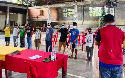 <p><strong>PLEDGING OF LOYALTY</strong>. Supporters of the New People's Army (NPA) pledging loyalty to the government during their surrender on Oct. 1 in Abuyog, Leyte. The recent surrender of 12 staunch mass-based supporters of the<br />NPA is a huge setback to the communist terrorist group's effort to influence communities, the Philippine Army said on Thursday (Oct. 7, 2021). <em>(Photo courtesy of Philippine Army)</em></p>