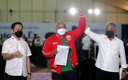 <p><strong>EYEING NO. 1.</strong> Senator Ronald “Bato” dela Rosa, the standard bearer of the ruling party, Partido Demokratiko ng Pilipinas-Lakas ng Bayan, files his certificate of candidacy at the Sofitel Harbor Garden Tent in Pasay City on Friday (Oct. 8, 2021). He is flanked by Senator Francis Tolentino (left) and party president and Energy Secretary Alfonso Cusi. <em>(PNA photo by Joey Razon)</em></p>