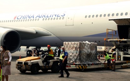 <p><strong>NEWLY DELIVERED.</strong> China Airlines Flight CI 701, carrying more than 2.7 million doses of Moderna and AstraZeneca vaccines, lands at Bay 9 of the Ninoy Aquino International Airport Terminal 1 on Friday (Oct. 8, 2021). The country has received more than 84 million doses of Covid-19 vaccines.<em> (PNA photo by Jess Escaros Jr.)</em></p>