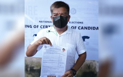 <p><strong>REELECTIONIST.</strong> House Deputy Speaker Mujiv Hataman shows his certificate of candidacy (COC) to supporters after filing it on Friday (Oct. 8, 2021). Hataman is seeking reelection for the lone district of Basilan province. <em>(Photo courtesy of Richard G. Falcatan - DXNO-Basilan)</em> </p>
