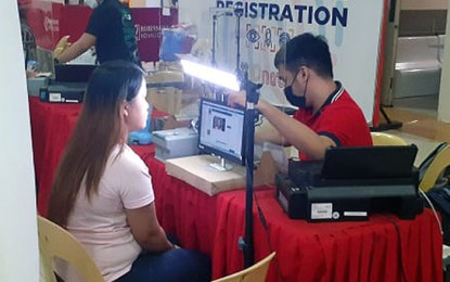 <p><strong>BIOMETRICS CAPTURE.</strong> A Philippine Statistics Authority employee captures the image of a national ID registrant at a mall in Fairview, Quezon City on Tuesday (Oct. 5, 2021). The national ID shall be a valid proof of identity that shall be a means of simplifying public and private transactions, enrolment in schools, and the opening of bank accounts. <em>(PNA photo by Ben Briones)</em></p>