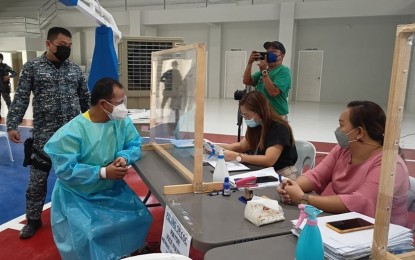 <p><strong>SAFETY FIRST.</strong> A candidate wearing a protective suit files his certificate of candidacy before the Commission on Elections-Bicol on Thursday (Oct. 7, 2021). The poll body will finalize the list of candidates for the May 2022 polls by December. <em>(Photo courtesy of Comelec-Bicol Facebook)</em></p>