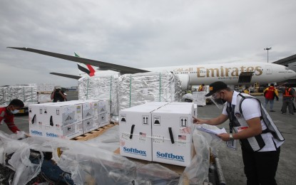 <p><strong>MORE US DONATIONS.</strong> John Paul Alarcon of the Bureau of Customs inspects the boxes containing the latest shipment of 924,300 doses of the Pfizer Covid-19 vaccine donated by the United States at NAIA Terminal 3 in Pasay City on Monday (Oct. 11, 2021). National Task Force (NTF) Against Covid-19’s sub-task group on current operations head Assistant Secretary Wilben Mayor said a portion of the Pfizer jabs will be allocated for the pediatric age-group vaccination.<em> (PNA photo by Avito C. Dalan)</em></p>