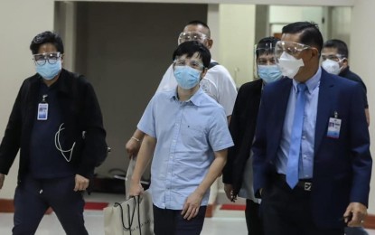 <p><strong>DETAINED.</strong> Senate security men escort Linconn Ong (center), director of Pharmally Pharmaceutical Corp., to the Office of the Sergeant-at-Arms on Sept. 21, 2021. Ong was ordered arrested by the Blue Ribbon Committee for his alleged refusal to answer questions regarding the company’s contracts with the government. <em>(Photo courtesy of Dick Gordon Facebook)</em></p>